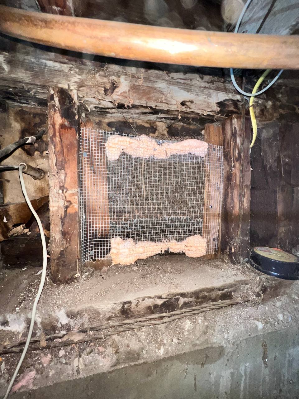 Opening sealed with wire mesh and foam in a Oakland home