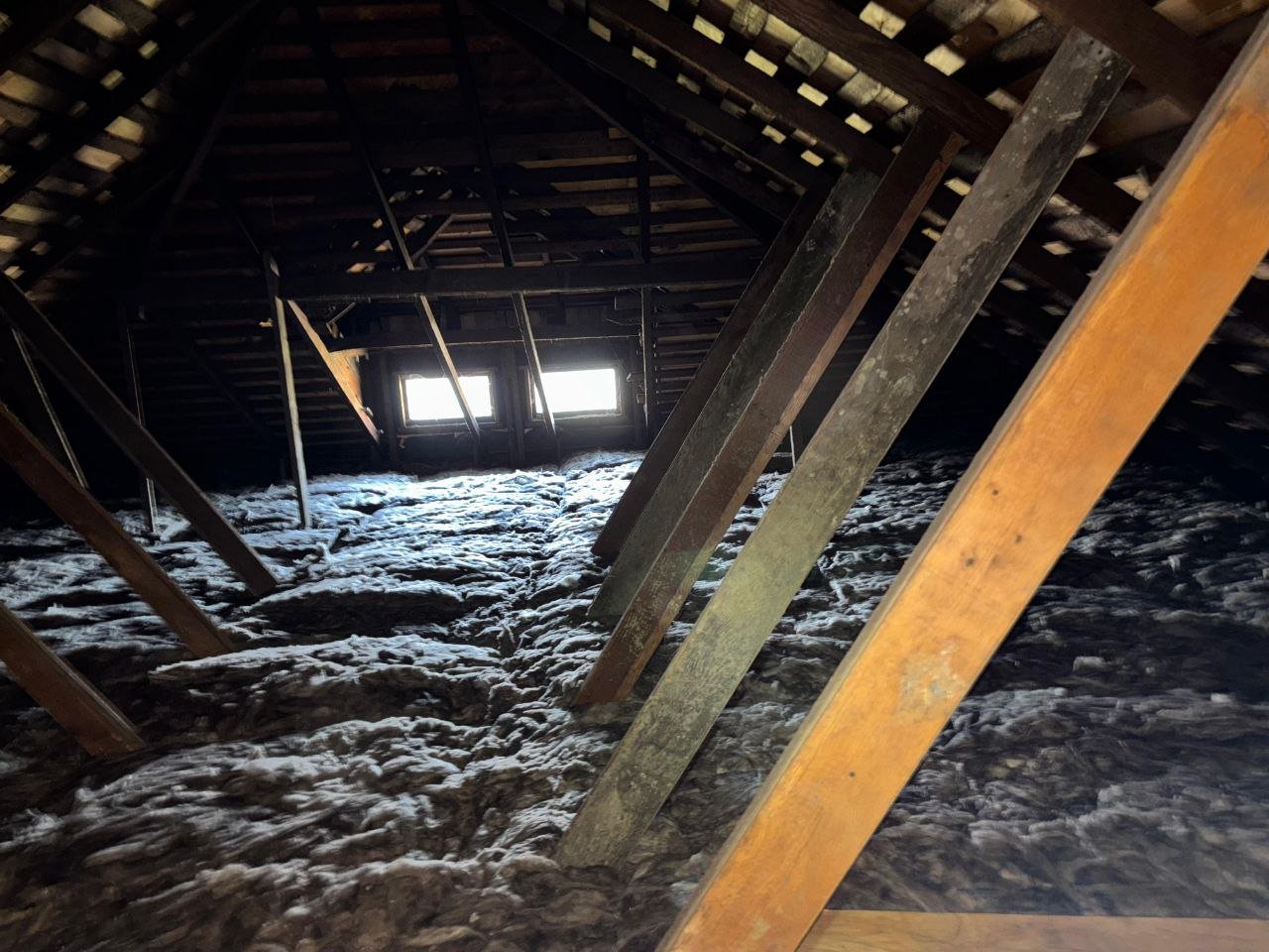 New insulation across a Oakland attic toward the gable vents