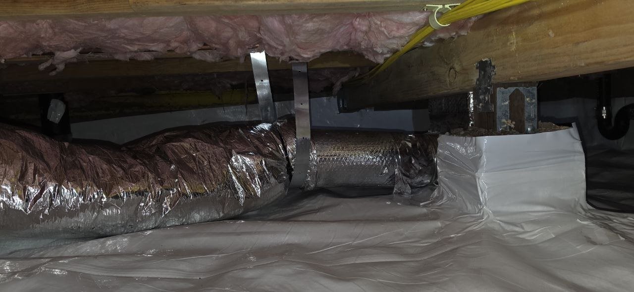 Vapor barrier sealed at a pier beside ductwork in a Pacifica crawl space