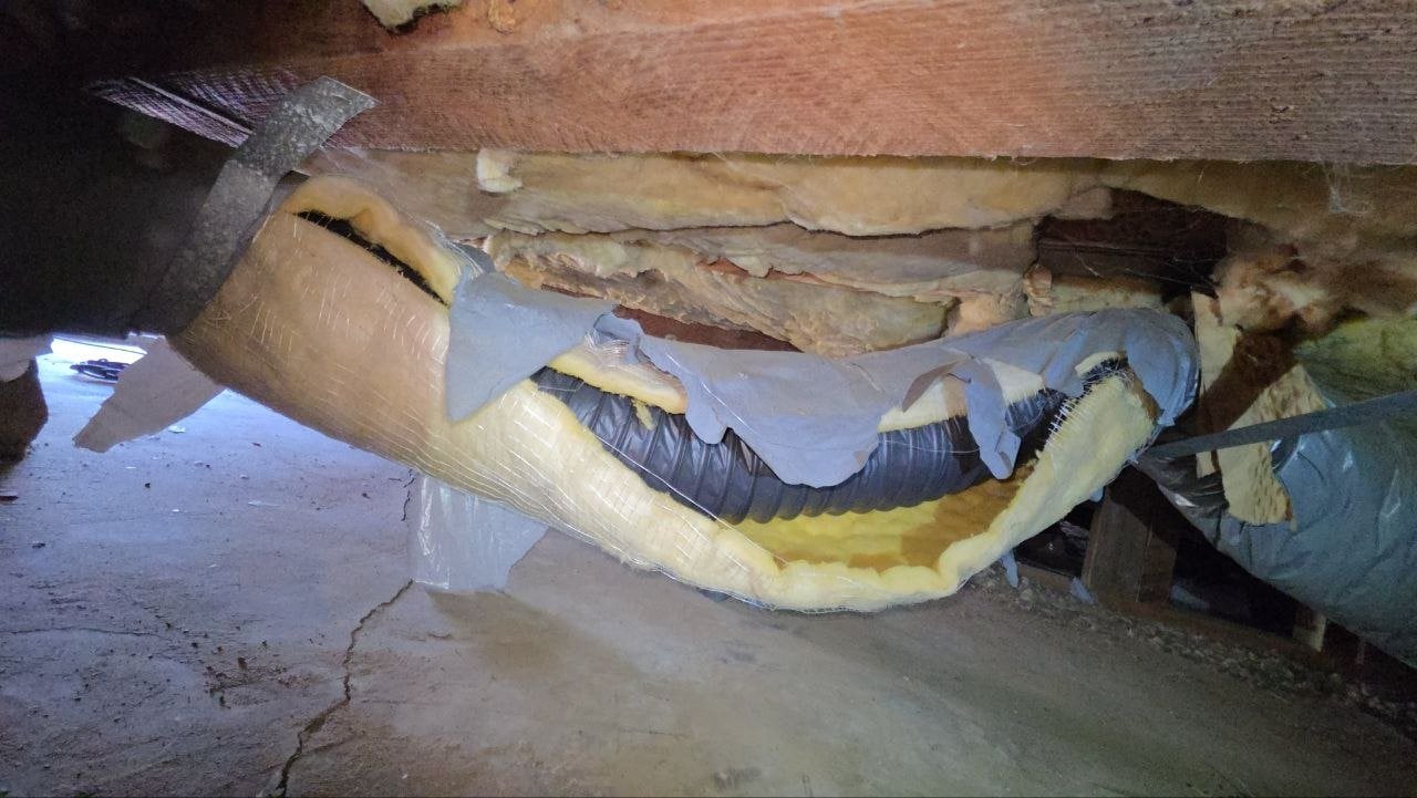 Old torn duct sagging in a Petaluma crawl space before work