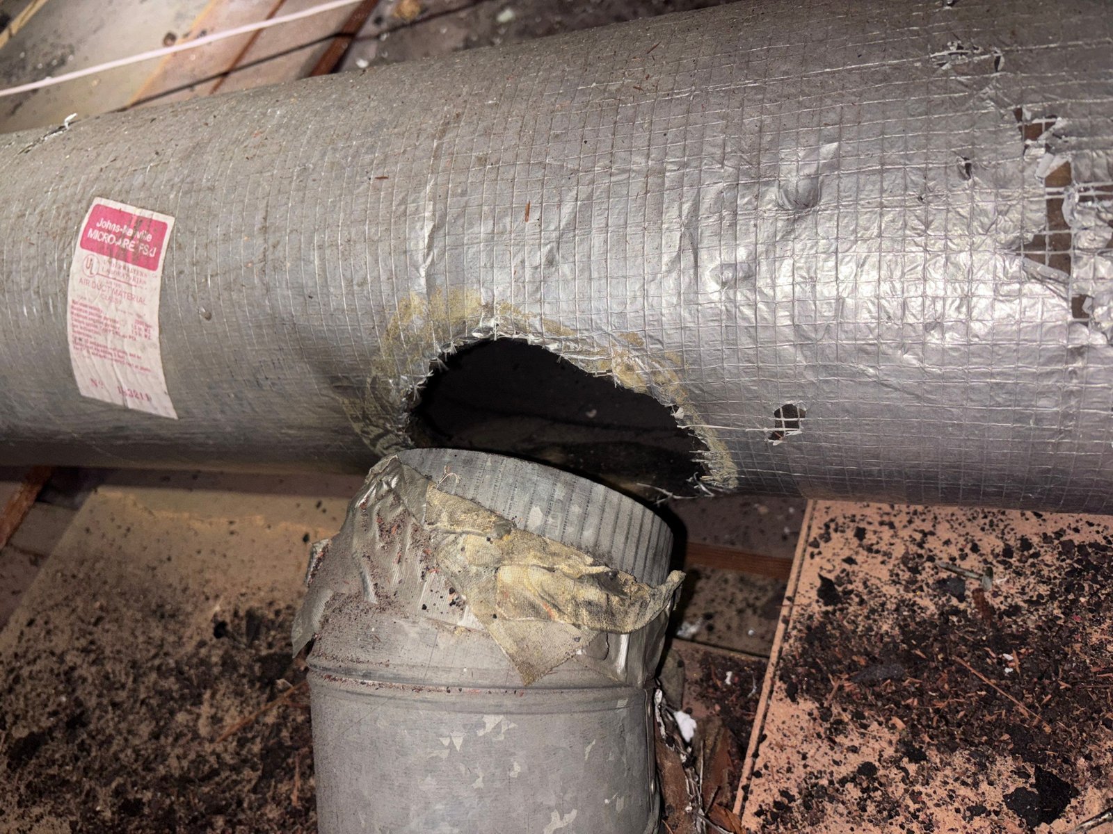 Old duct with torn wrap in a Redondo Beach attic before work