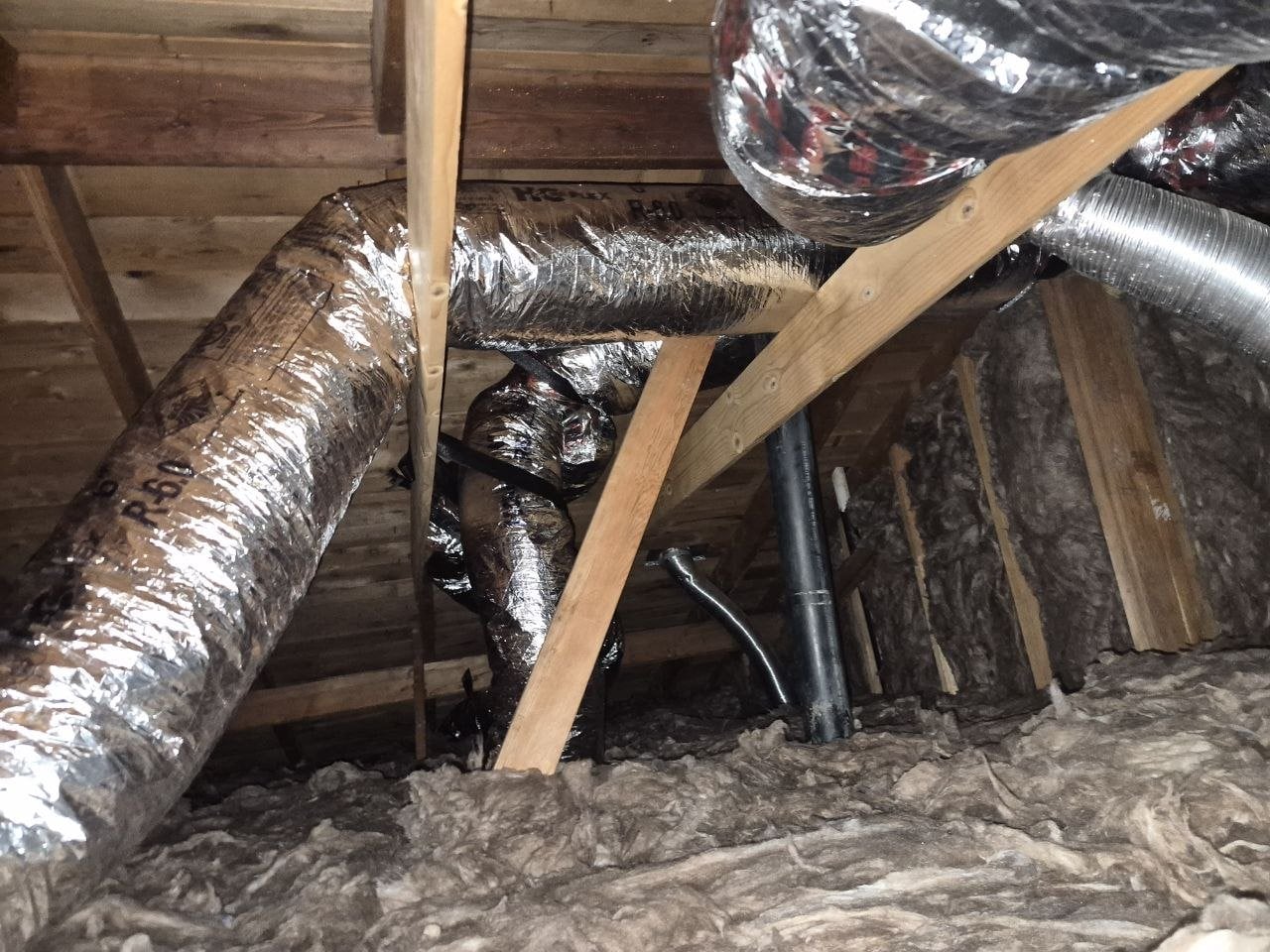 New flexible air ducts above new attic insulation in San Jose