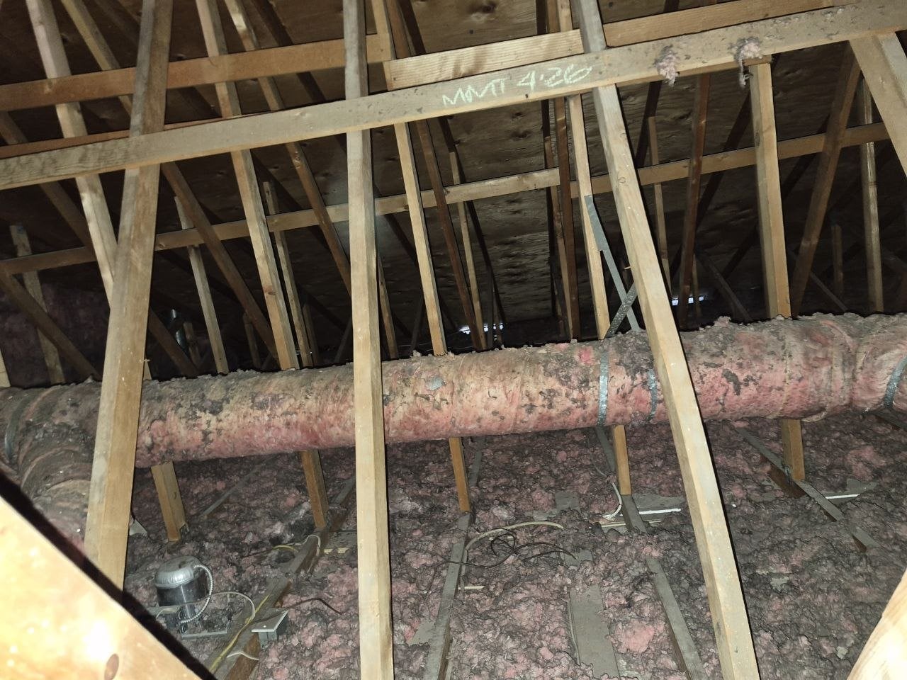 Old duct run in old loose-fill insulation in a San Jose attic before work