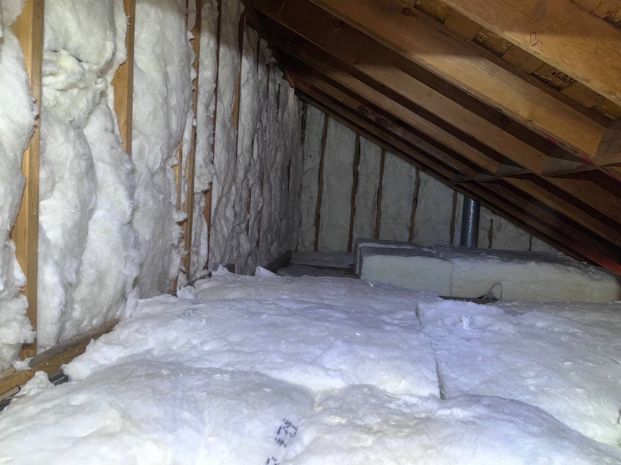 New insulation batts in attic wall framing in San Jose