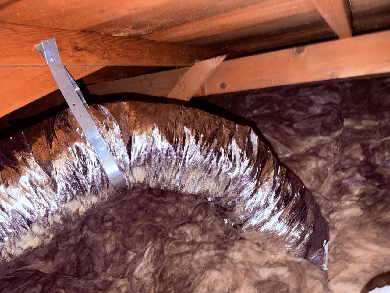 New flexible air duct strapped above new insulation in a San Jose attic