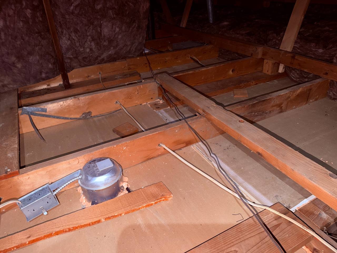Cleaned attic deck around a recessed light in San Jose, new insulation beyond