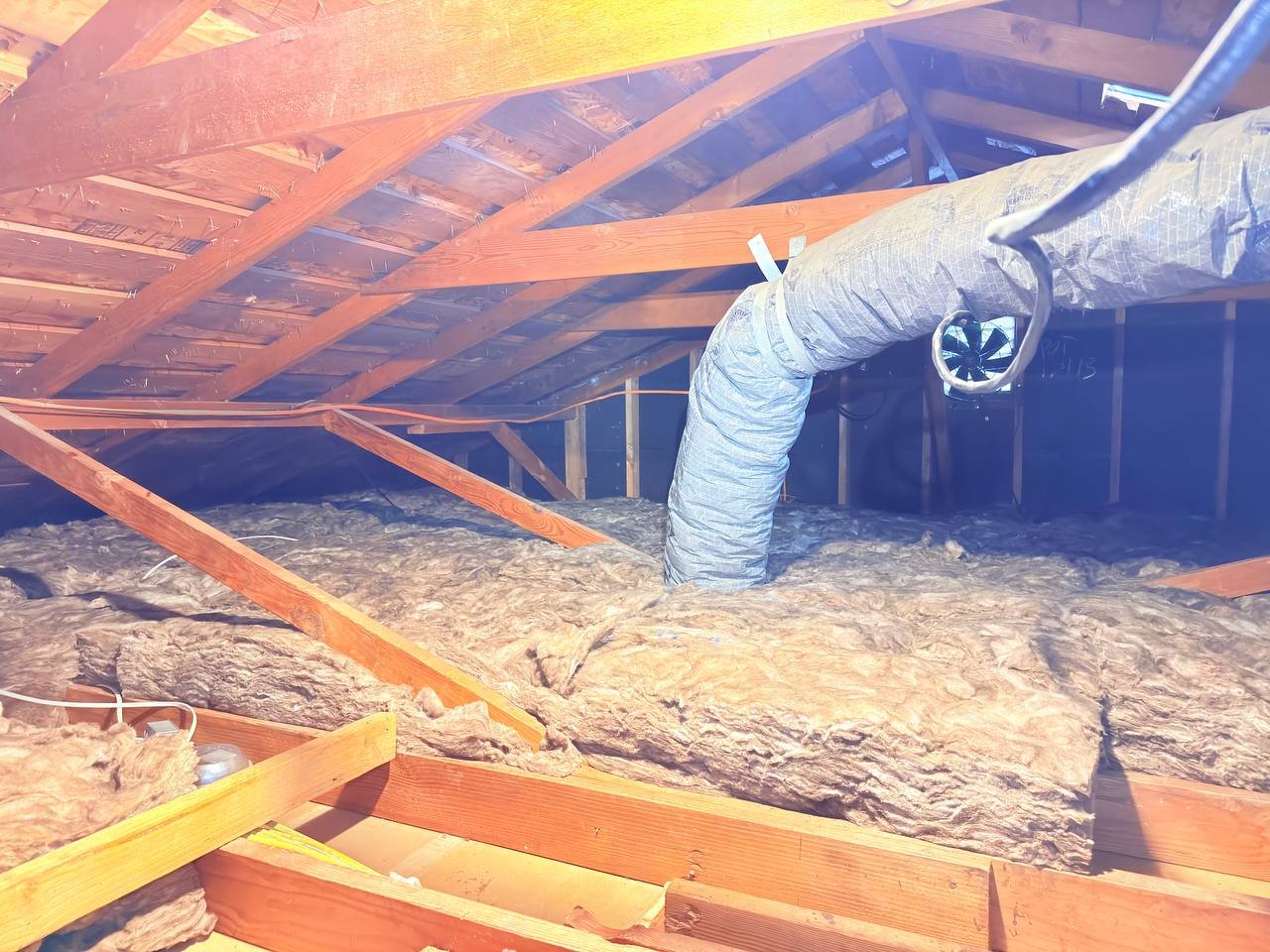 New insulation laid around ducts in a San Jose attic