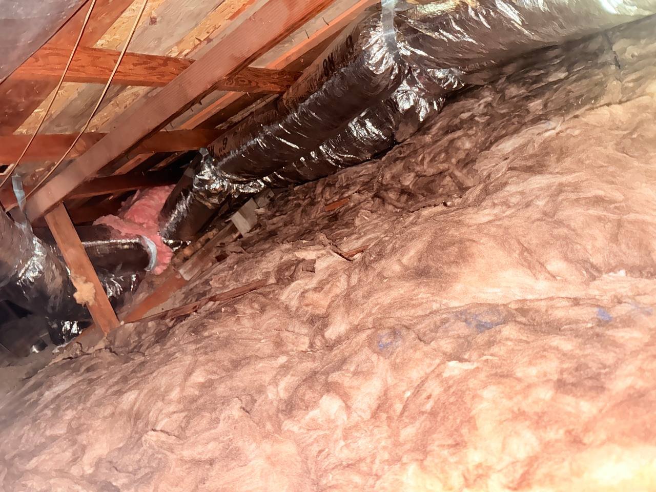 New insulation laid around ducts in a San Jose attic