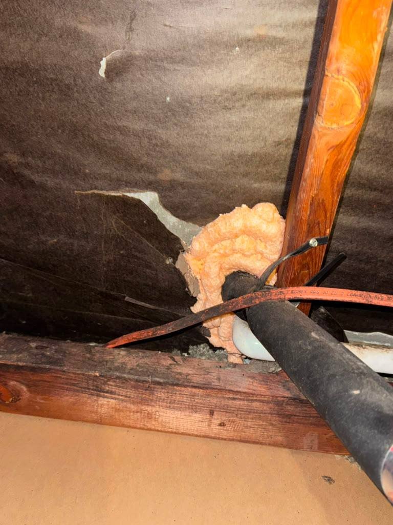 Foam air sealing around an attic penetration in San Jose