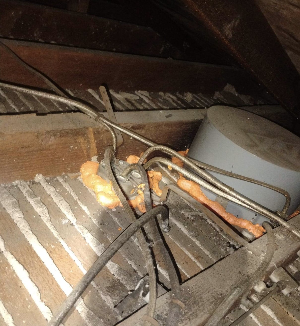 Foam air sealing around an attic penetration in San Jose
