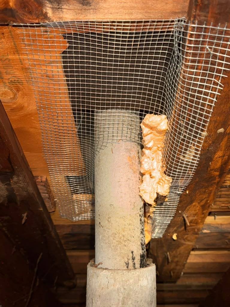 Wire mesh and foam around a pipe in a San Rafael attic