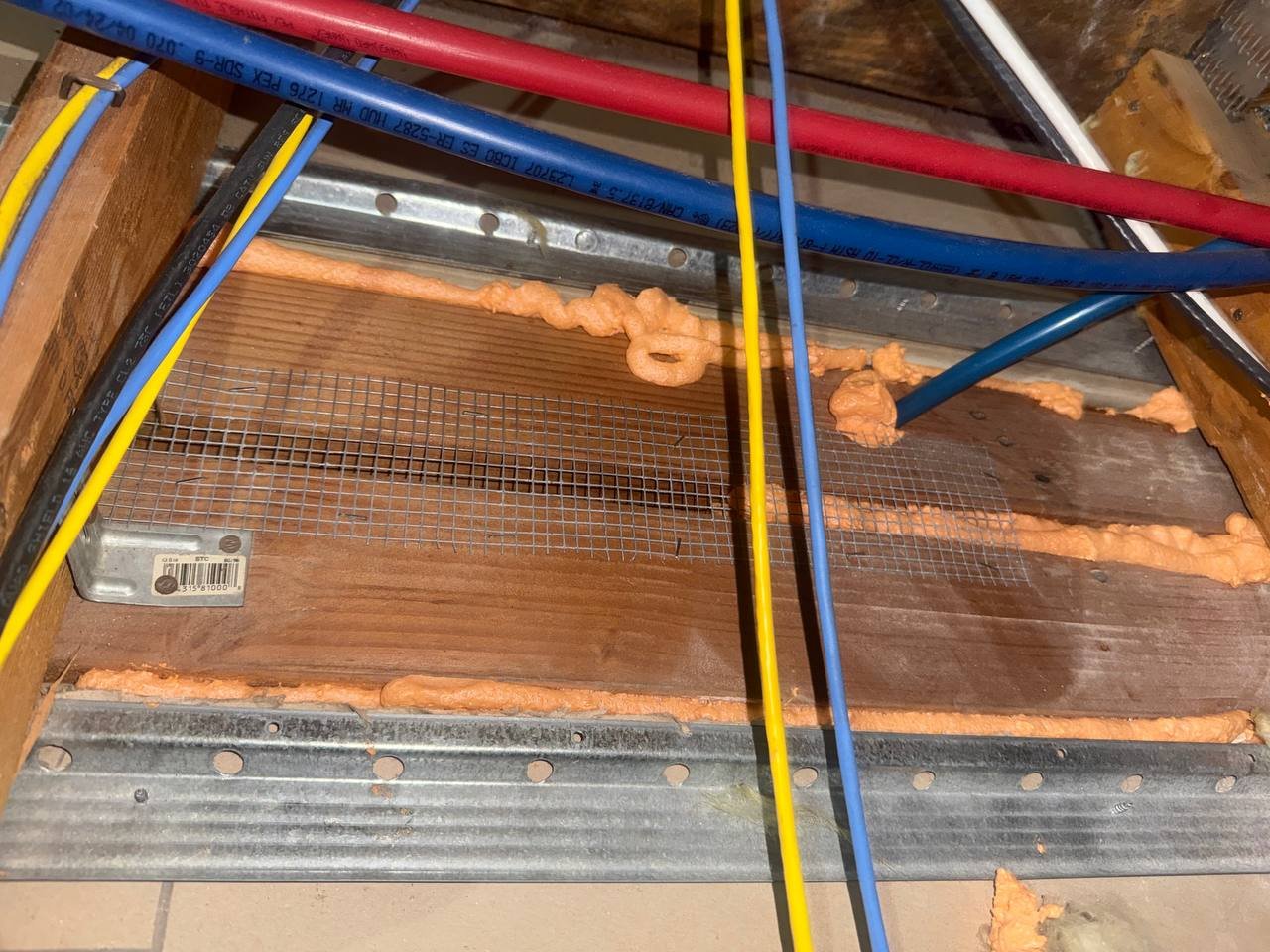 Wire mesh and foam sealing along the top plate in a Santa Clara attic