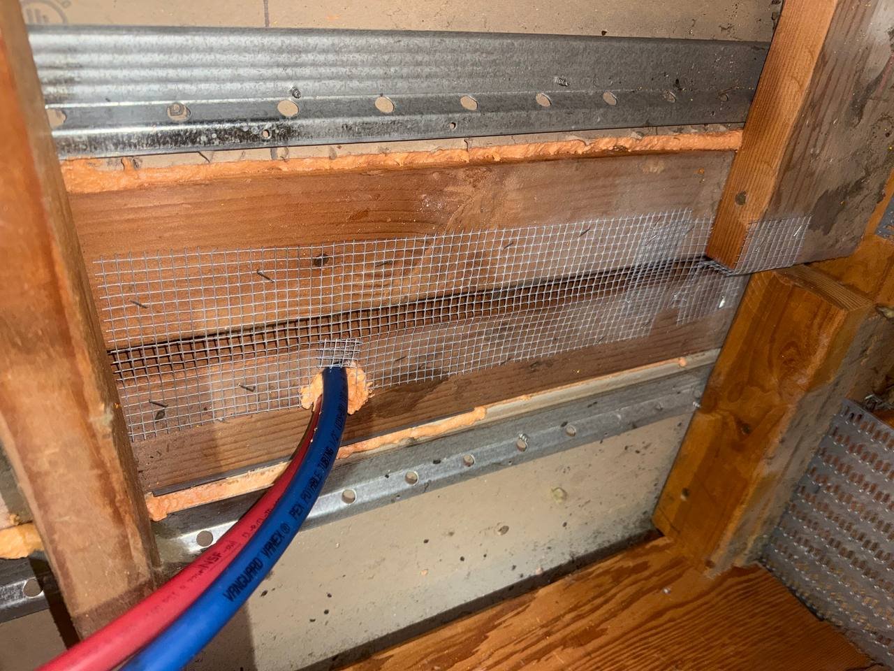 Wire mesh and foam sealed around pipes in a Santa Clara attic