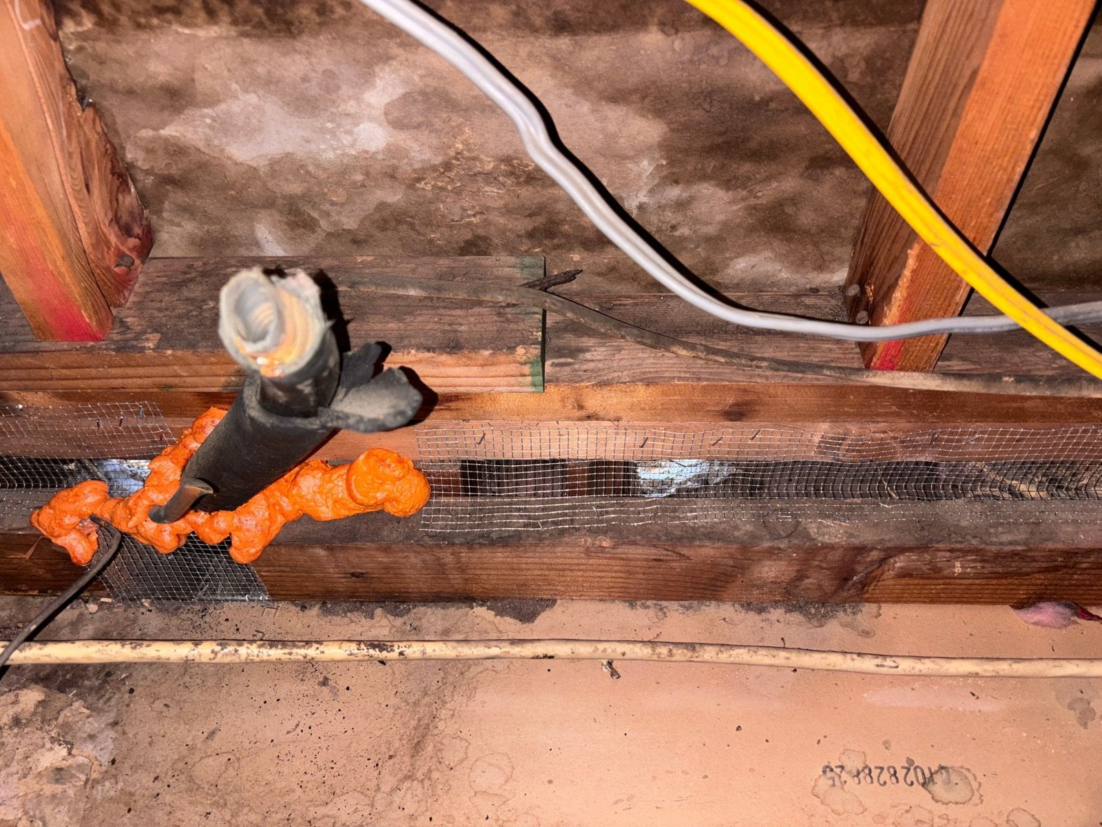 Wire mesh and foam sealed around a pipe in a Santa Clarita attic