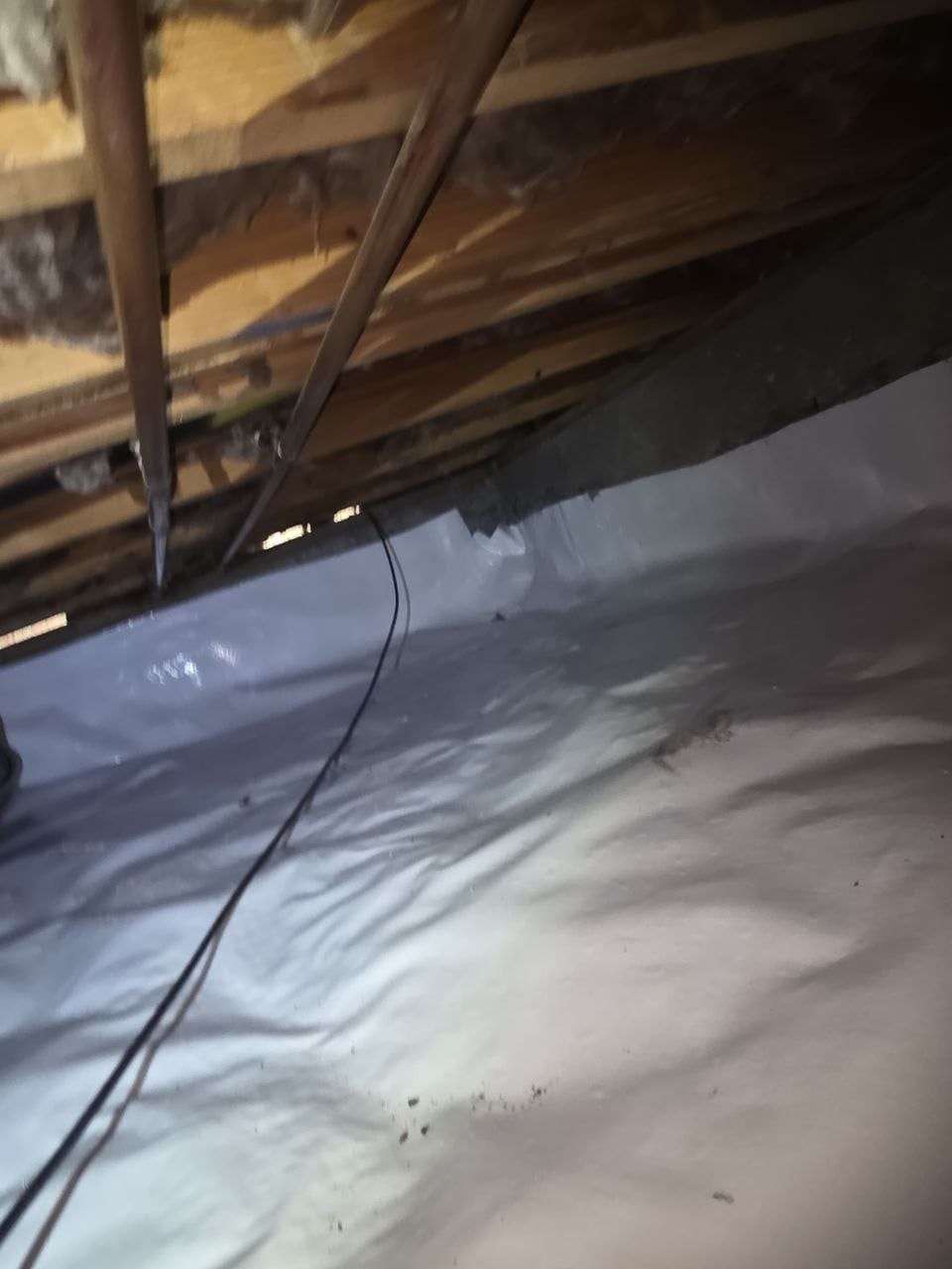 Vapor barrier run up the foundation wall of a Santa Rosa crawl space