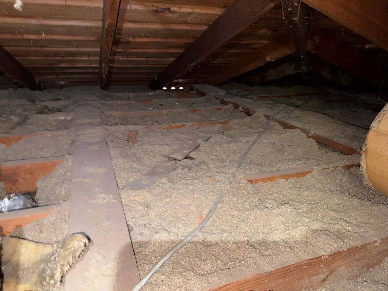 Tracy attic before work, old insulation and debris