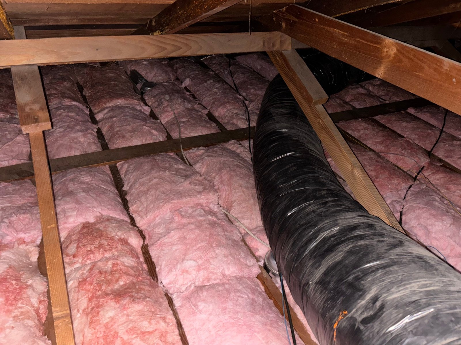 New insulation laid around ducts in a Upland attic