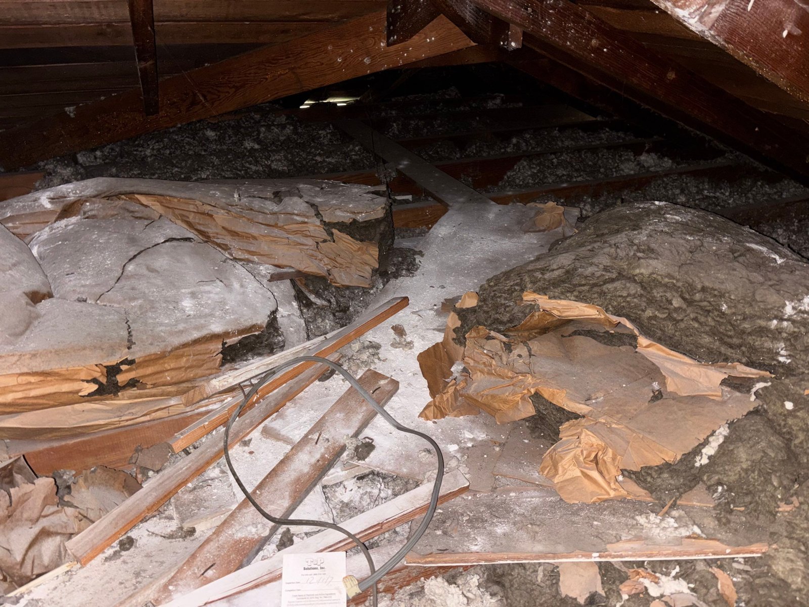 Upland attic before work, old insulation and debris