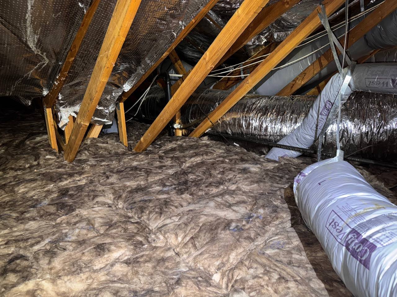 New insulation laid around ducts in a Vacaville attic