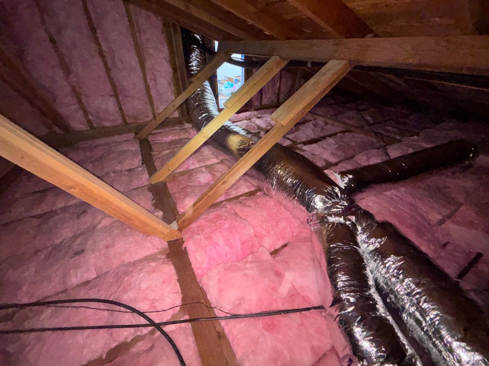 New insulation laid around ducts in a Westlake Village attic