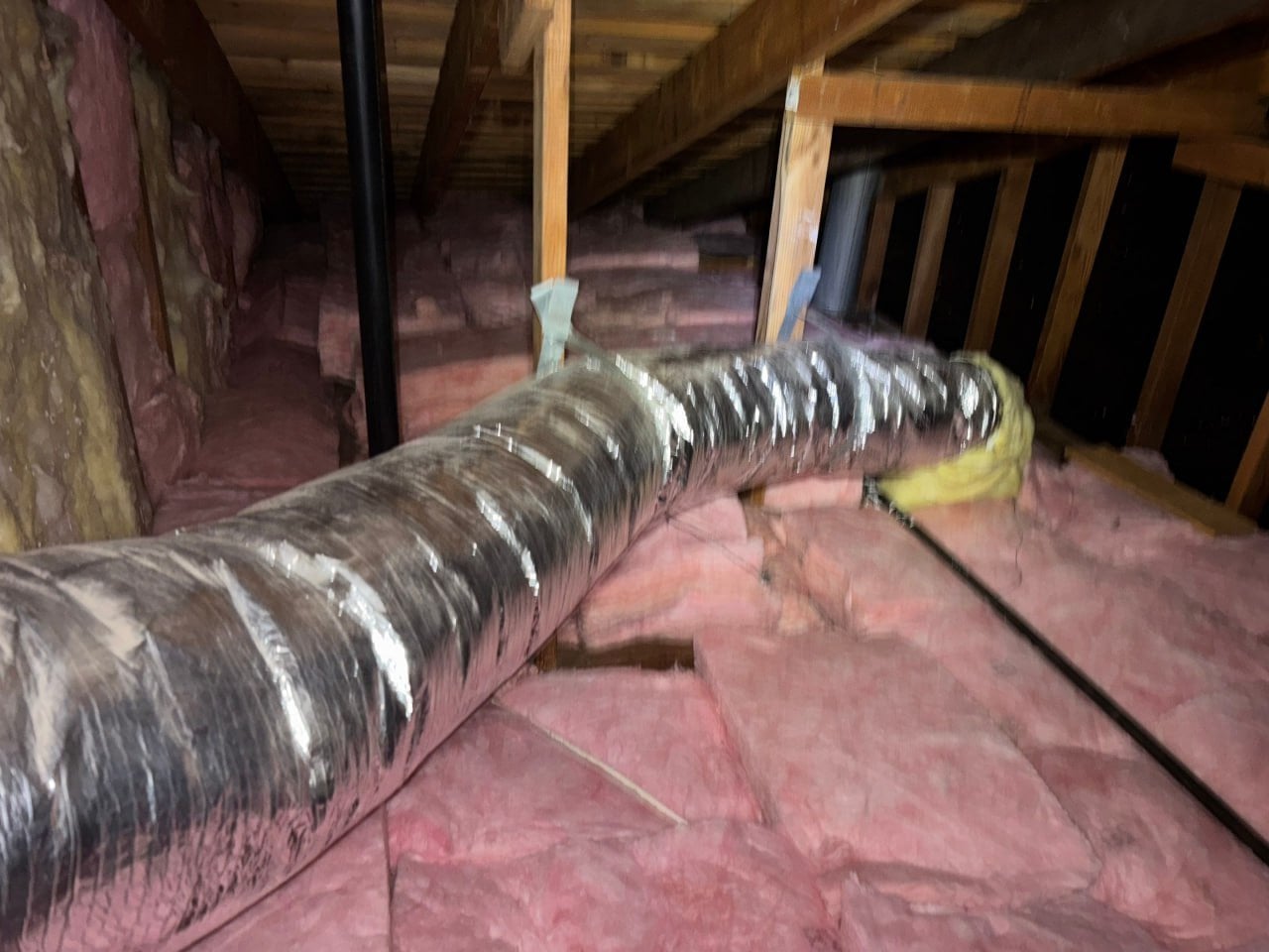 New insulation laid around ducts in a Westlake Village attic