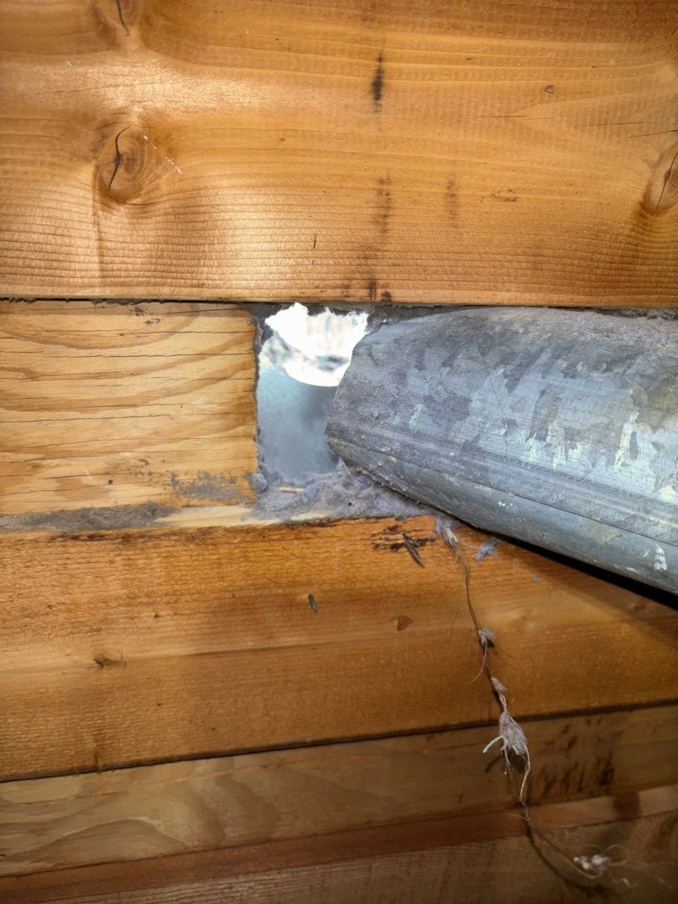 Open gap around a duct through attic framing in Westlake Village before work