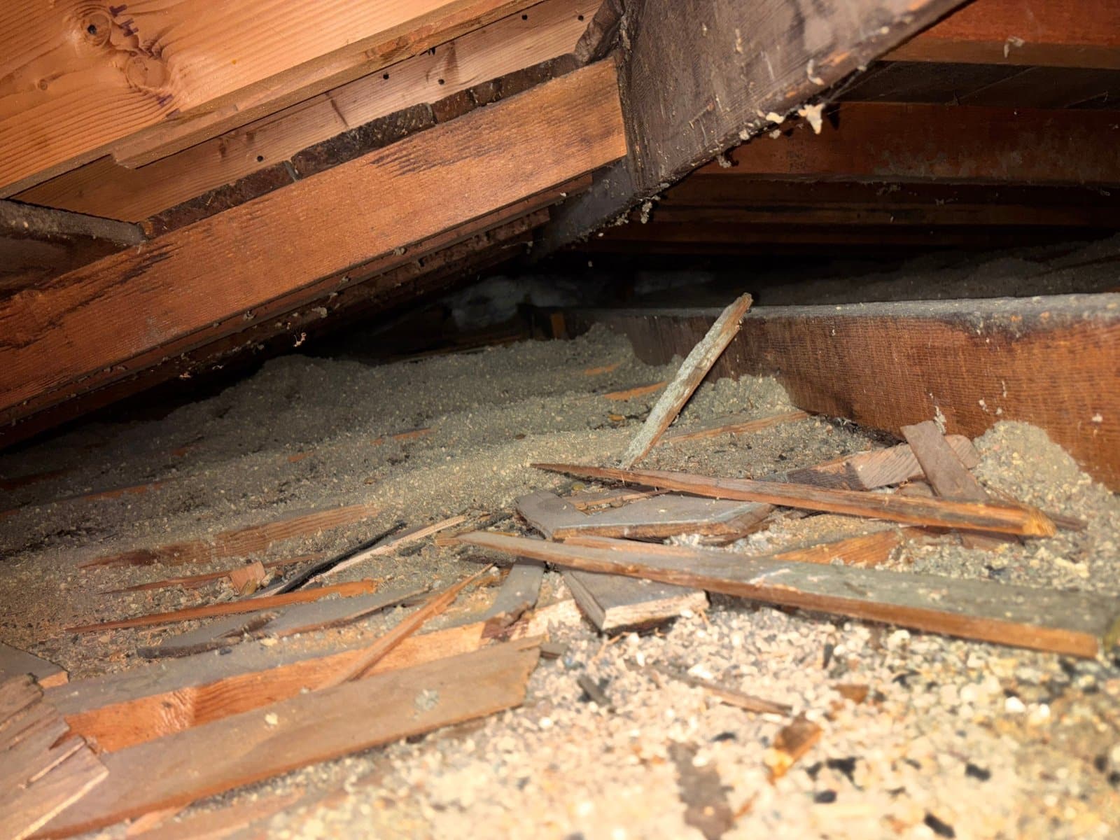 Debris and old insulation near the eaves of the Pasadena attic before work