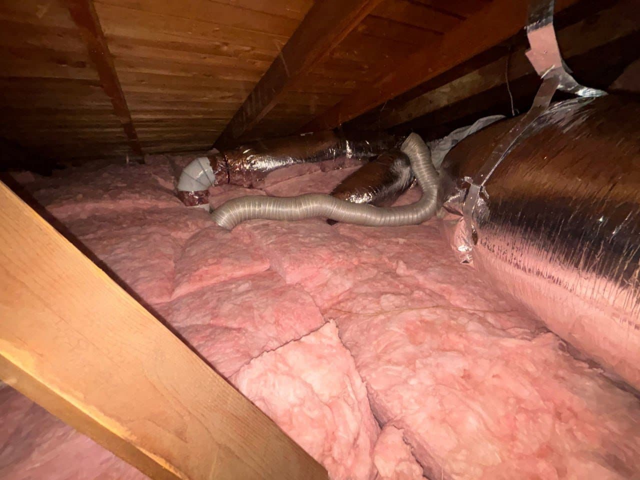 New fiberglass batts around ducts in a Pasadena attic